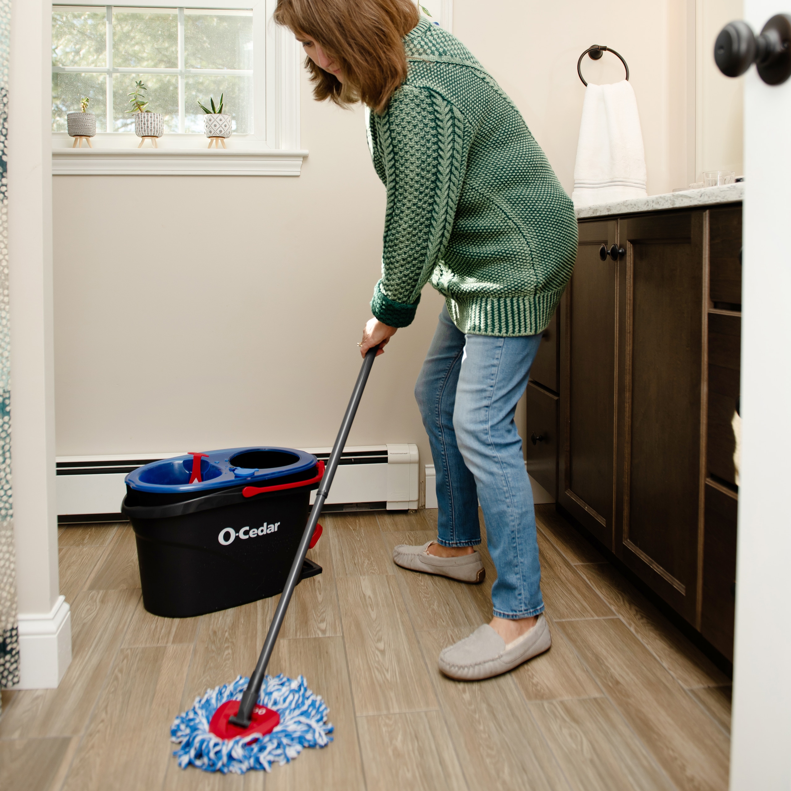 Woman mopping using O-Cedar mop and bucket