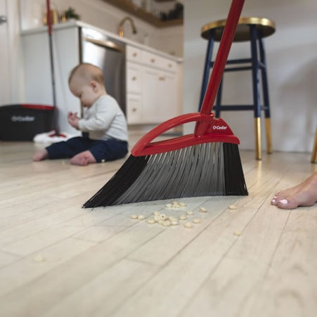 Sweeping floor with indoor O-Cedar broom